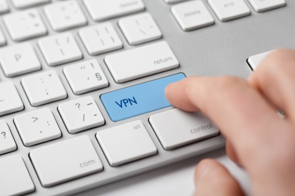 vpn services ipvanish finger on blue vpn key on white computer keyboard